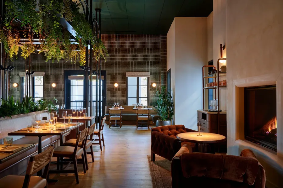 Hotel bar with green tiled walls and timber ceiling
